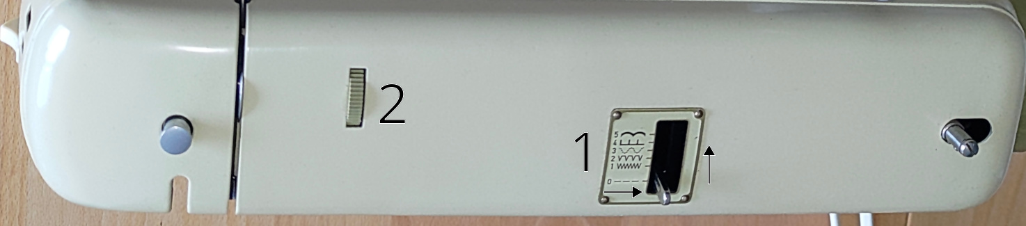 Shows the top of the Minimatic 707. There is a 1 next to the stitch pattern selector and a 2 next to the tension wheel.